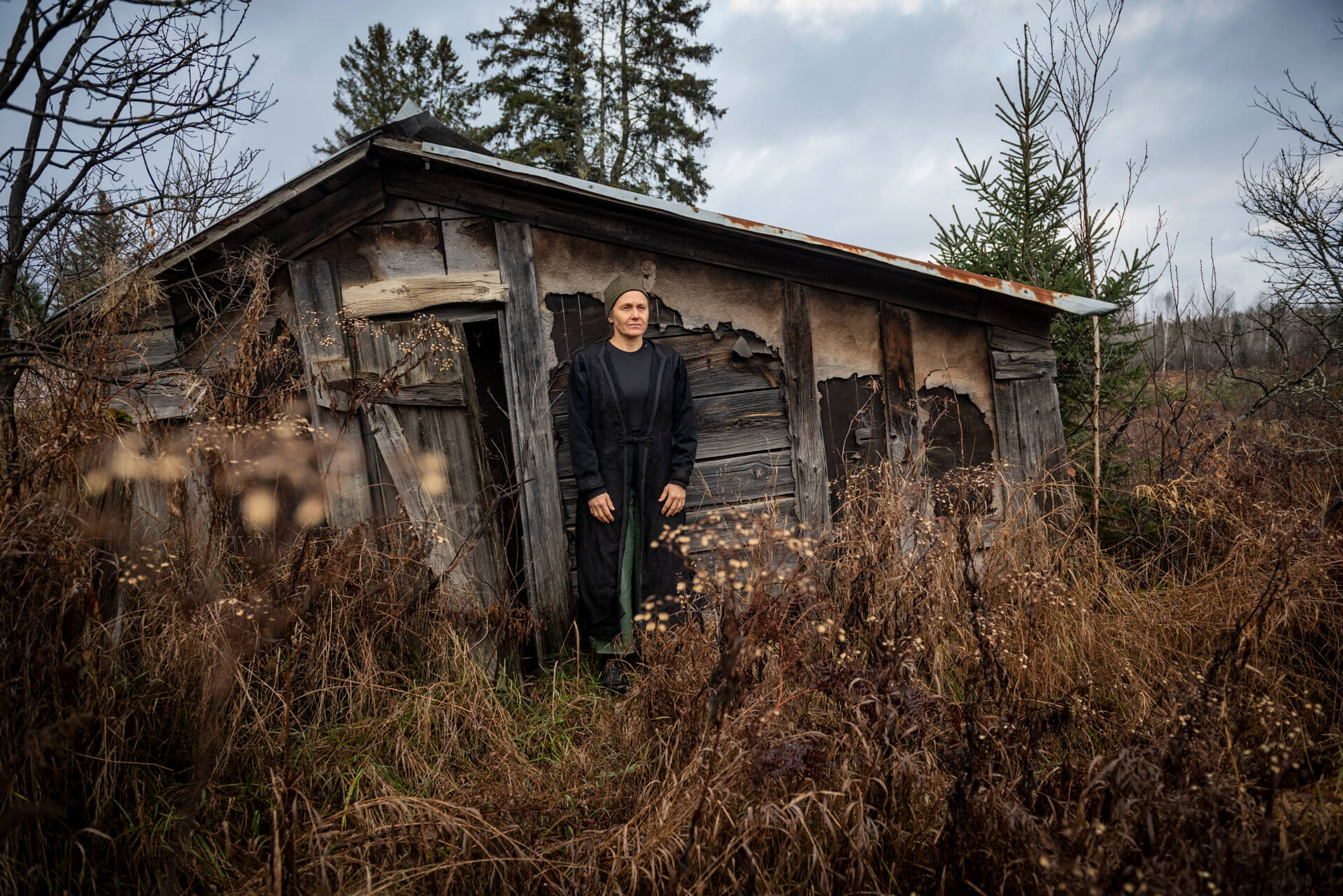 standing infront of abandoned shack