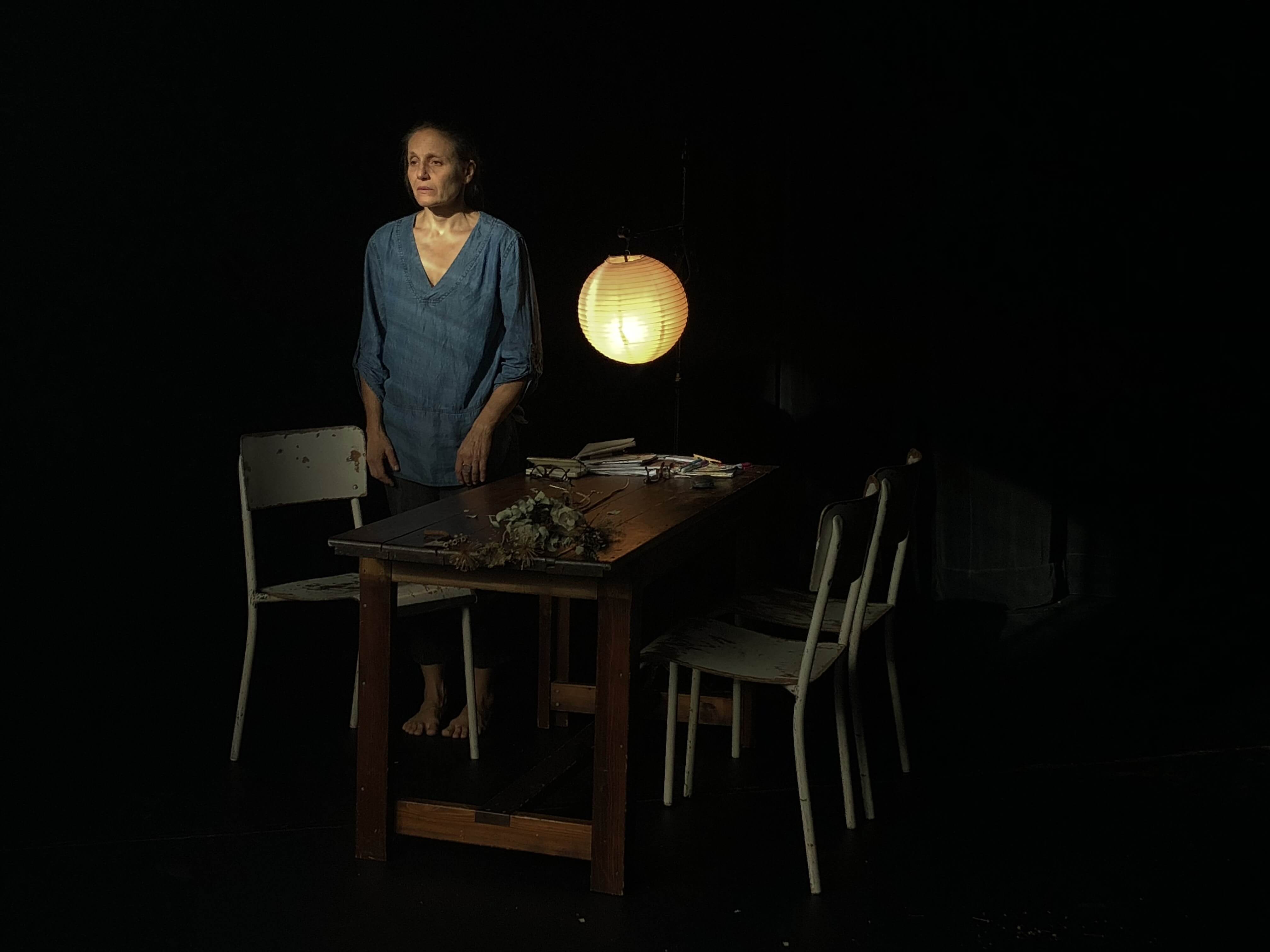 standing by table and lamp